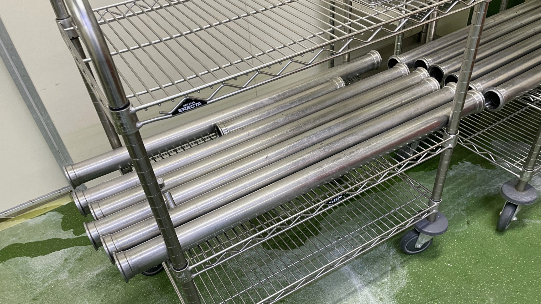 The previous stainless piping with cheese buildup and manual cleaning